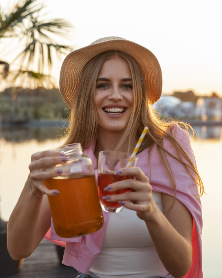 front-view-woman-with-delicious-kombucha-outdoors